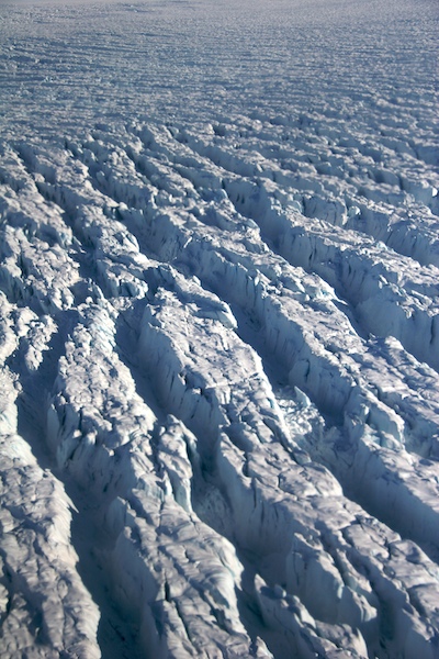 Resembling the cracked skin of age, these fissures in the Greenland ice sheet reveal bright blue ice that has been concealed for aeons.
